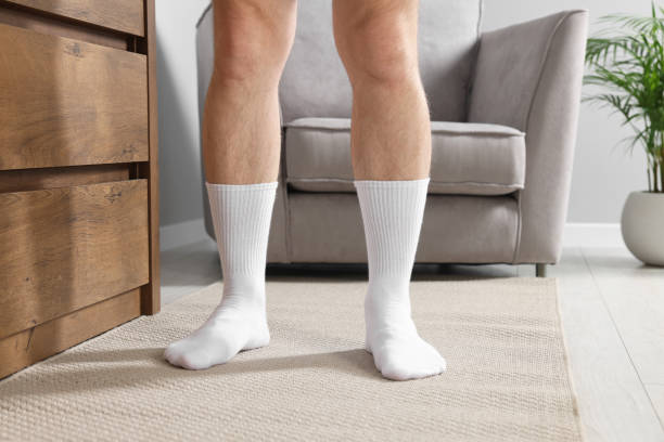 istock Man in stylish white socks indoors, closeup 1858716169