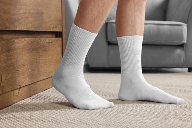 istock Man in stylish white socks indoors, closeup 1858716174