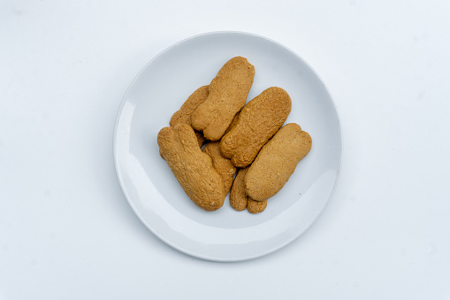 Homemade Gingersnap Cookies or Ginger biscuits on white plate isolated on white background.