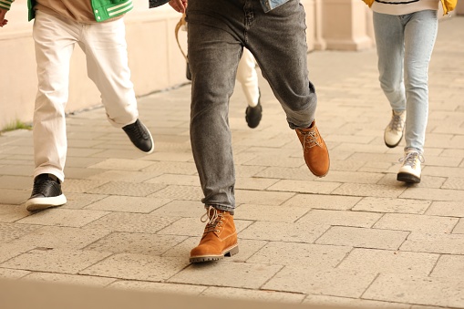 Being late. Group of students running outdoors, closeup