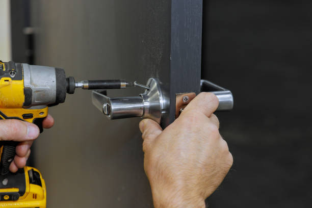 istock Using a screwdriver, carpenter installs lock handles on room door 1858778508