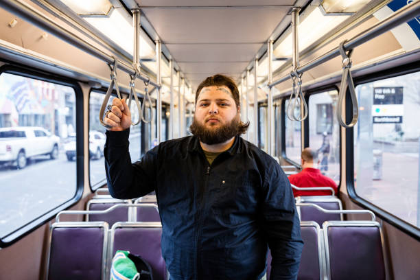 istock Tattooed Man Rides Public Transit Train Through City for Work 1858781636