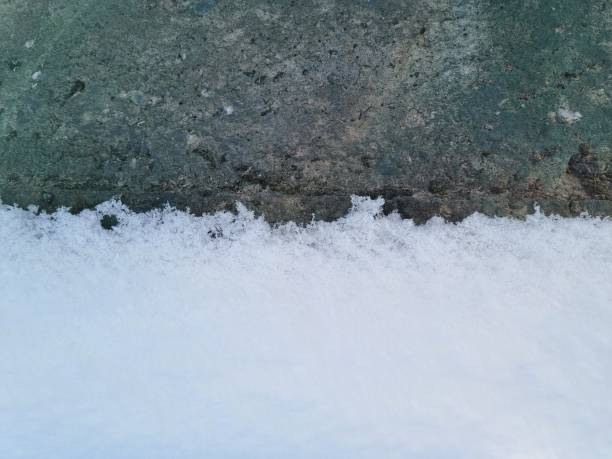 istock Snow on concrete close-up 1858786853