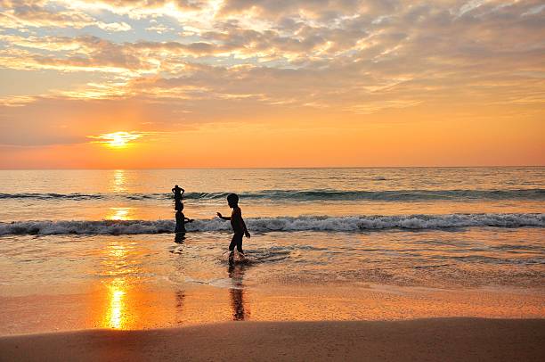 istock children have happy time on the beach under sunset light 185884152