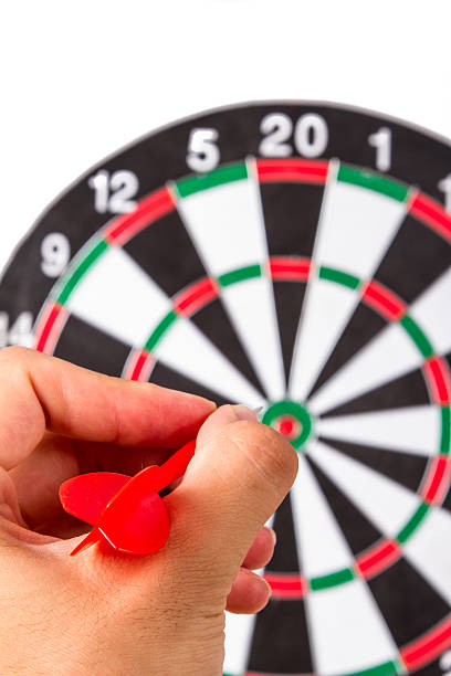 istock Hand Holding Arrow and Throwing Dart Board 185884854