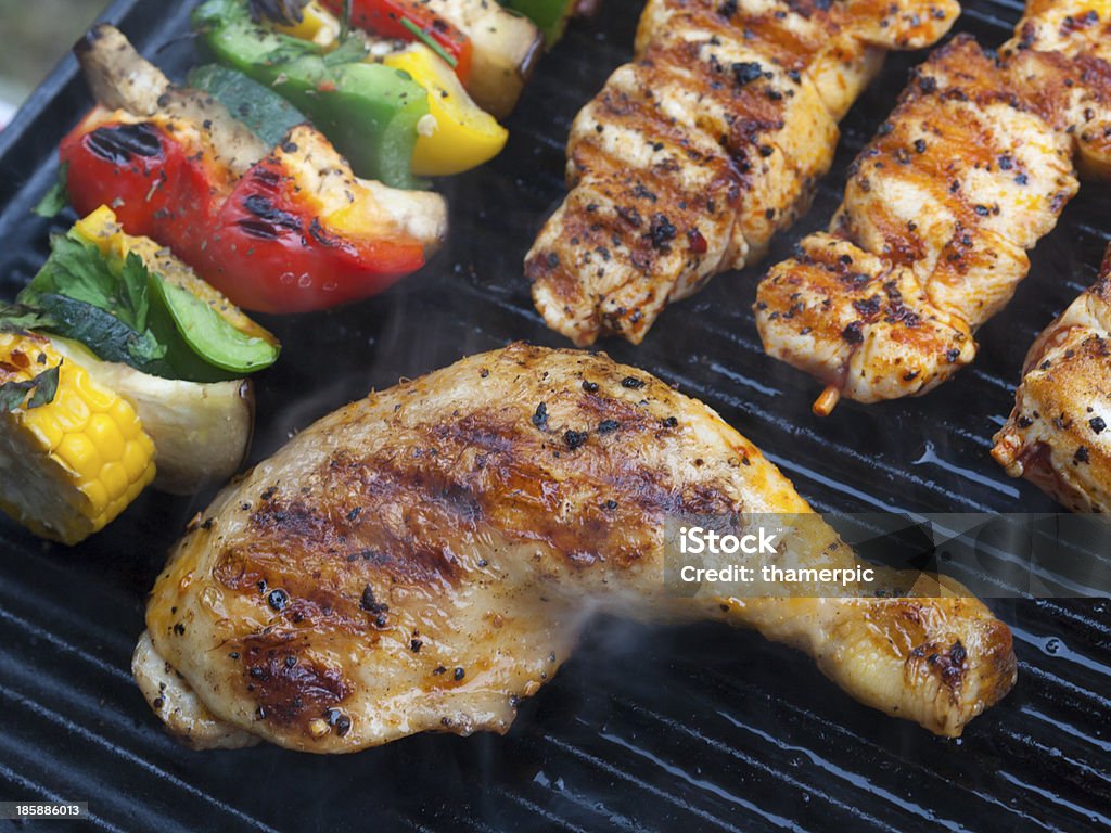 Delicious BBQ chicken meat and vegetables on a barbecue Delicious BBQ food Jerk Chicken Stock Photo