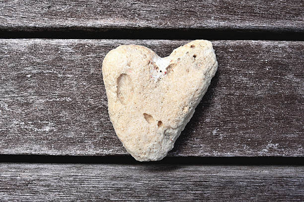 istock heart symbol on old wood background 185887261