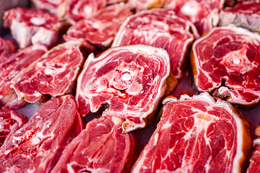 Picture of goat meat cut into small pieces for sale on a meat stall in a Muslim bazaar.