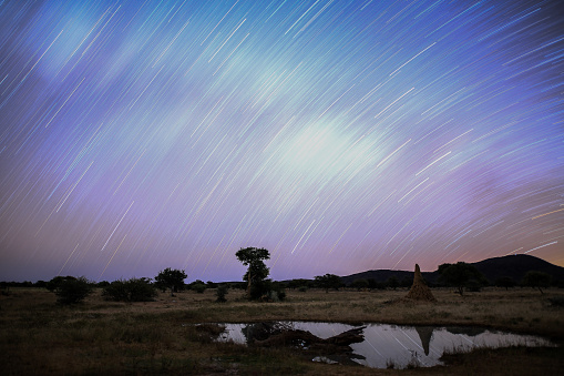 starry african sky with milkyway reflects in a pond. Long exposure