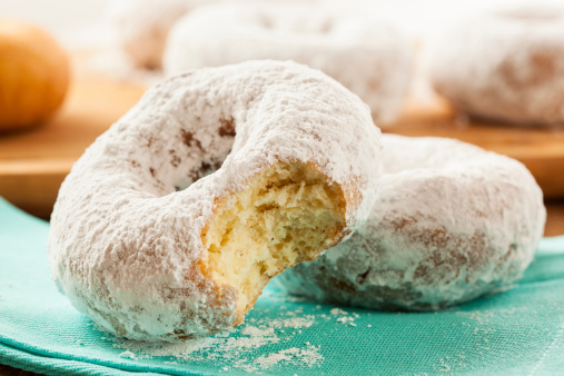 White Homemade Powdered Donuts on a Background