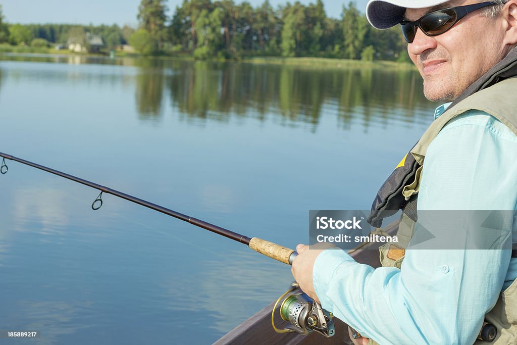 Portrait of a fisherman fishing on a lake Fisherman fishing spinning Fishing Stock Photo