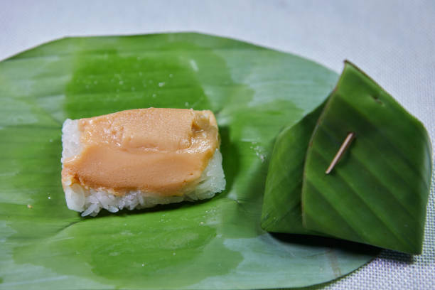 istock Sticky rice with steamed custard wrapped with banana leaf 1858892650