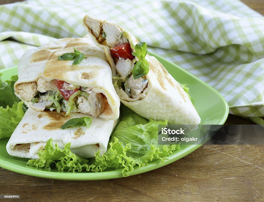 burrito (doner) with chicken and vegetables burrito (doner) with chicken and vegetables wrapped in pita bread Appetizer Stock Photo