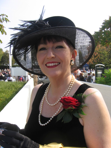 A Lady wearing a black dress at a outside event during Summer in England.