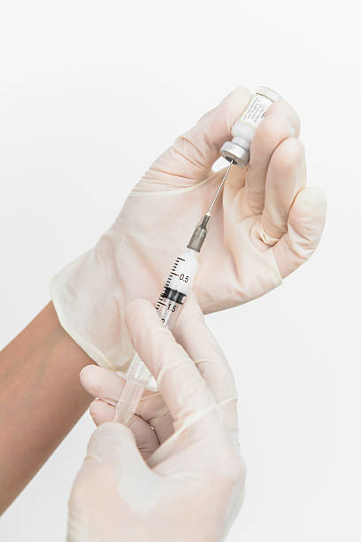 istock hands of a nurse administer the injection 185891255