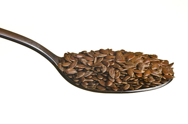 Flax seeds in a spoon isolated over white background