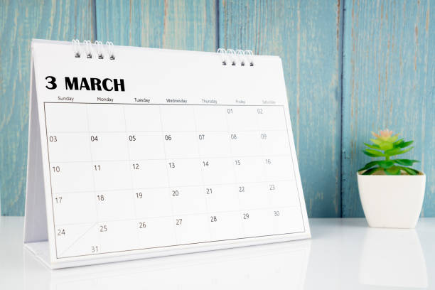 istock March 2024 calendar on the white table with blue wooden. 1858916901