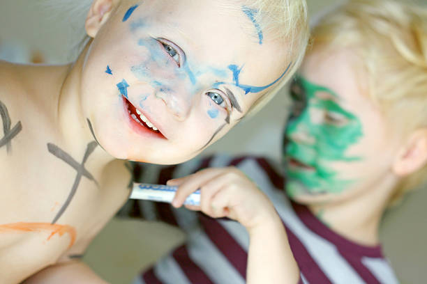 istock Children Coloring Their Faces with Markers 185891732
