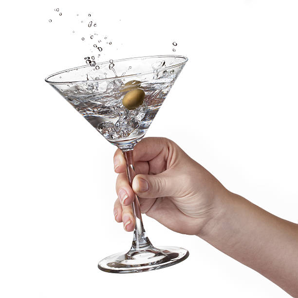 Splash of martini in womans hand isolated stock photo