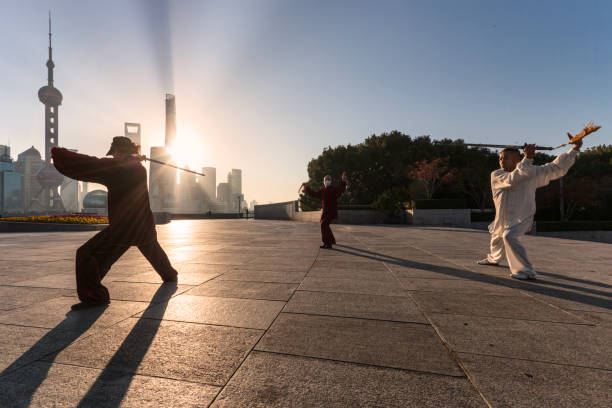 Group of people practicing Tai Chi on The Bund in Shanghai stock photo