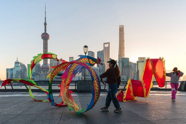 Group of people practicing with kite ribbons on The Bund in Shanghai stock photo