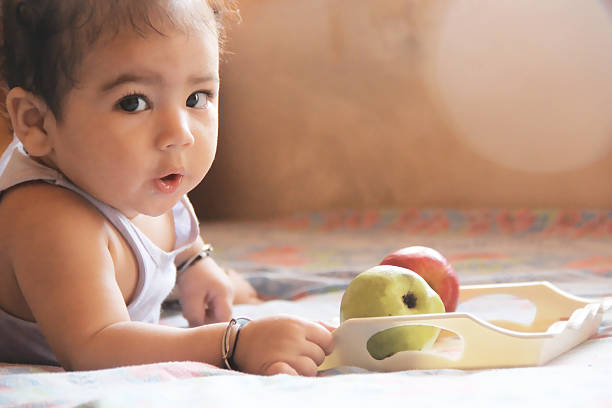 istock Baby Eating Fruits 185898923