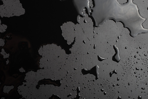 Water ( rain ) drops on glass on  a Black Background 