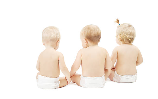 istock Baby in diapers sitting back side view over white 185899706