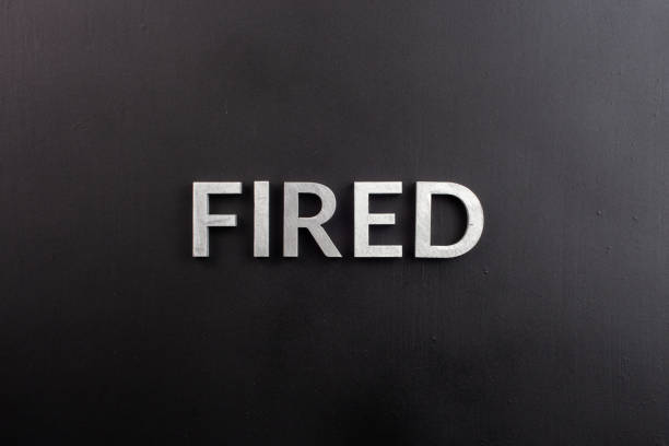 istock the word fired laid with silver metal letters on flat black surface 1858998213