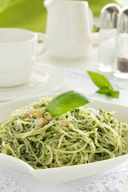 Spaghetti with pesto sauce. Spaghetti with pesto sauce. cooked selective focus vertical pasta stock pictures, royalty-free photos & images