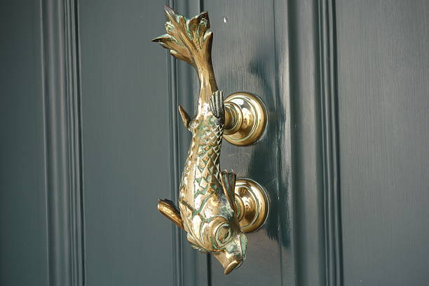 Antique interior golden doorknob on an old wooden door