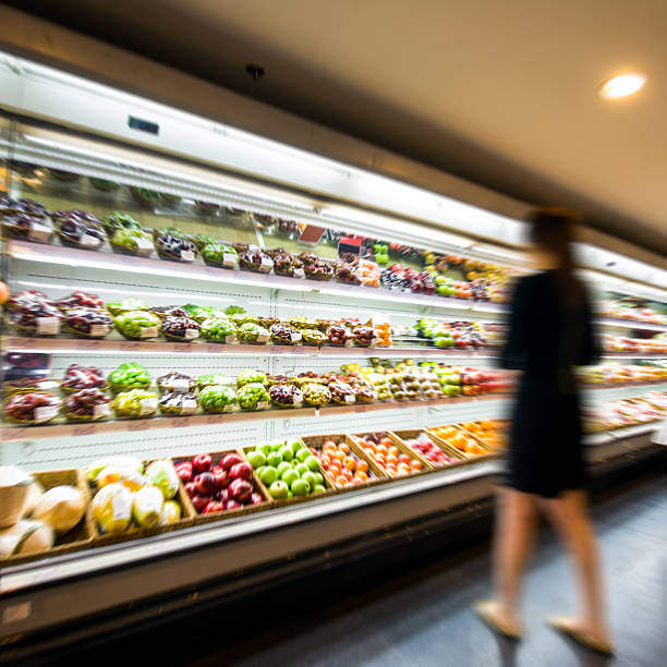 istock A woman perusing the fruit section of a supermarket 185902857