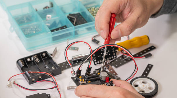 istock Close-up of hands assembling robotics educational toy. STEM education concept 1859028582