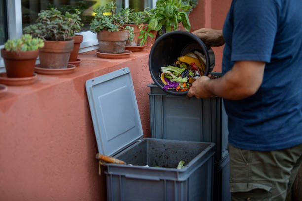 Man composting organic remains in home composter Man composting organic remains in home composter - Buenos Aires - Argentina eisenia fetida stock pictures, royalty-free photos & images