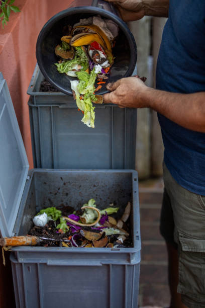 istock Man composting organic remains in home composter 1859047038