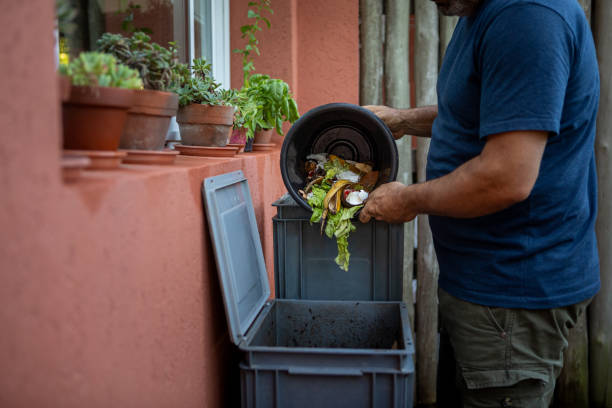 istock Man composting organic remains in home composter 1859047049
