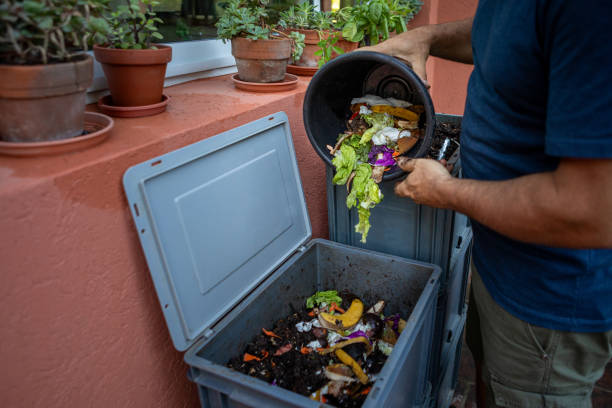 istock Man composting organic remains in home composter 1859047051