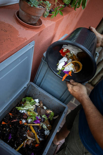 istock Man composting organic remains in home composter 1859047563