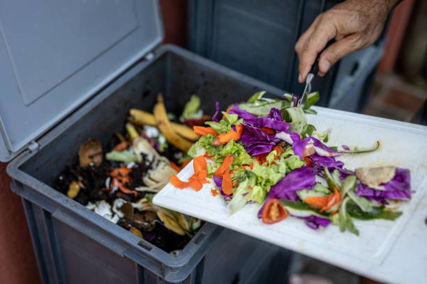 istock Man composting organic remains in home composter 1859049141