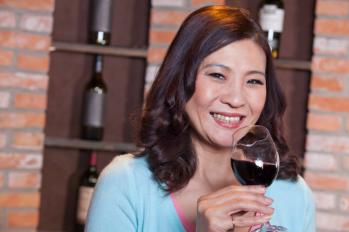 Mature Woman Enjoying a Glass of Wine