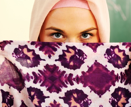 Muslim Arabic teenage student inside the high school classroom posing