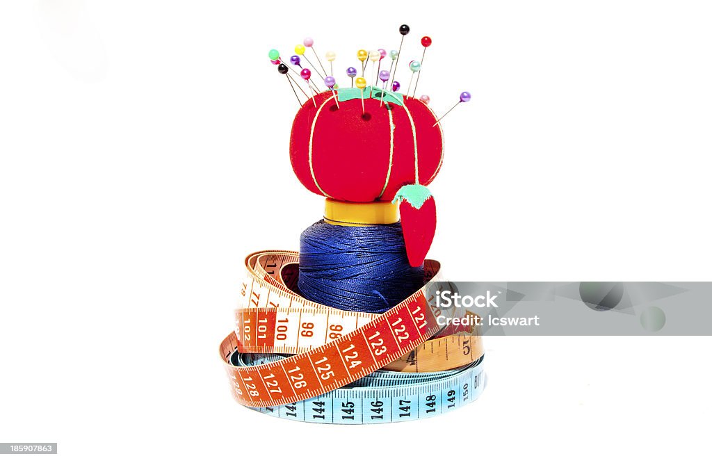 Three Tape Measures Coiled Around Cotton Roll Three tape measures coiled around roll of cotton with Pin Cushion Anger Stock Photo