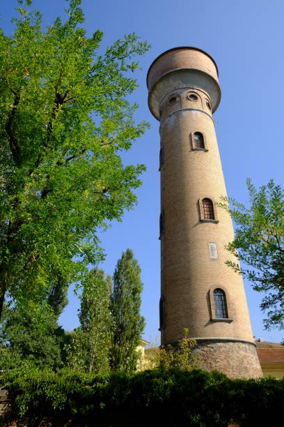 istock Cylindrical brick tower soars into the blue sky. 1859120654