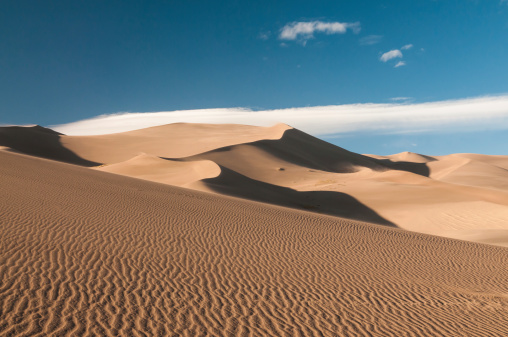 Impressive Sand Dunes with clouds and blue sky, seen in Great Sand Dunes National Park, Colorado, USA. 