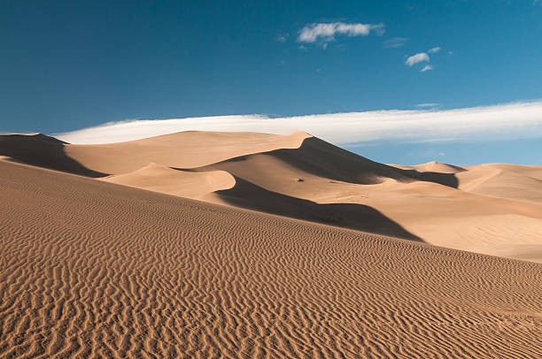 Great Sand Dunes National Park - USA Impressive Sand Dunes with clouds and blue sky, seen in Great Sand Dunes National Park, Colorado, USA.  great sand dunes national park stock pictures, royalty-free photos & images
