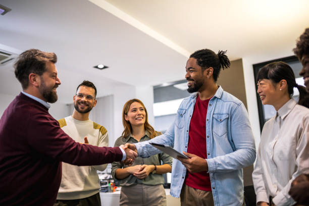istock Multiethnic colleagues meeting their new associate in their modern office. 1859130478
