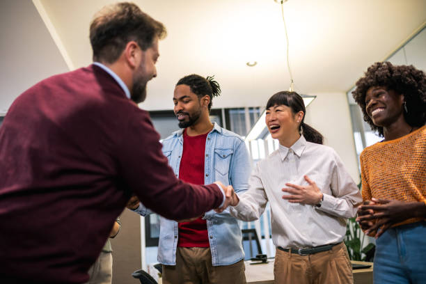 istock Multiethnic colleagues meeting their new associate in their modern office. 1859130482