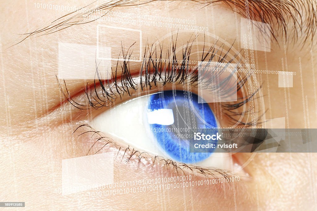 Woman blue eye looking at a digital virtual screen Woman blue eye looking on digital virtual screen close-up Eye Stock Photo