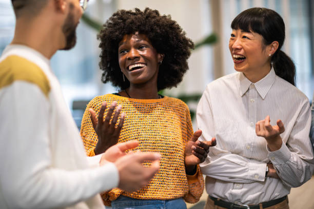 istock Multiethnic colleagues standing together and talking about work in their modern office. 1859137863