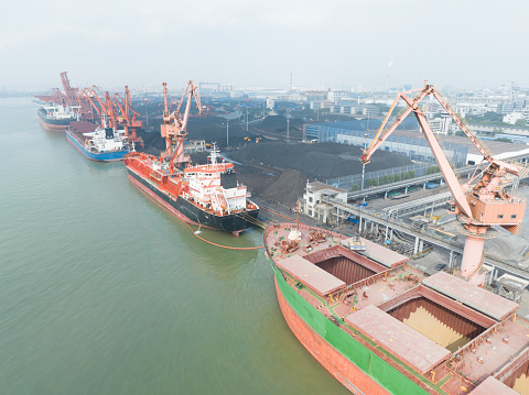 Aerial view of a container ship being unloaded/loaded.